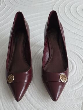 Coach Maroon Pointed-Toe Pumps with Gold Medallion